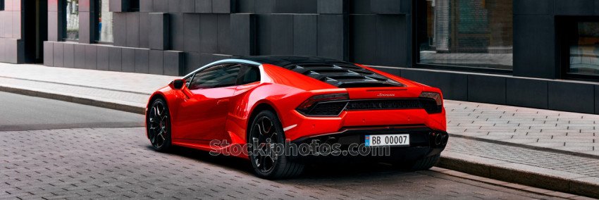 Red Lamborghini Huracan in front of office building on Wismargata street