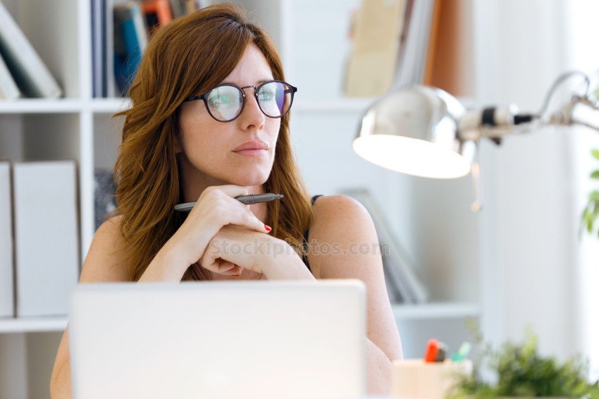 Beautiful young woman working with her laptop at home.