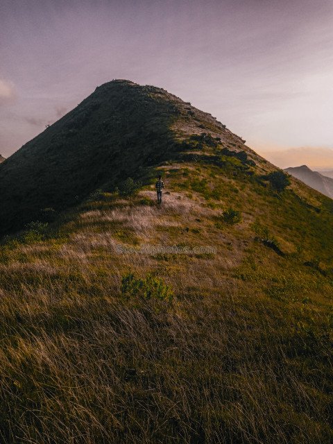 sunset in the mountains,a person walking in the mountain